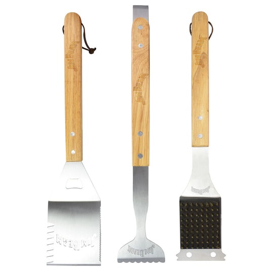 The Jim Beam 3-Piece BBQ Tool Set is shown with stainless steel tools and wooden handles: a spatula on the left, tongs in the center, and a grill cleaning brush with brass bristles on the right.