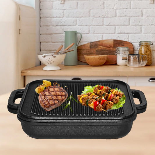 A Jim Beam Cast Iron Skillet and Griddle Set by Jim Beam sits on a kitchen counter, holding grilled steak, roasted potatoes, and two meat and vegetable skewers with kitchen utensils and jars in the background.