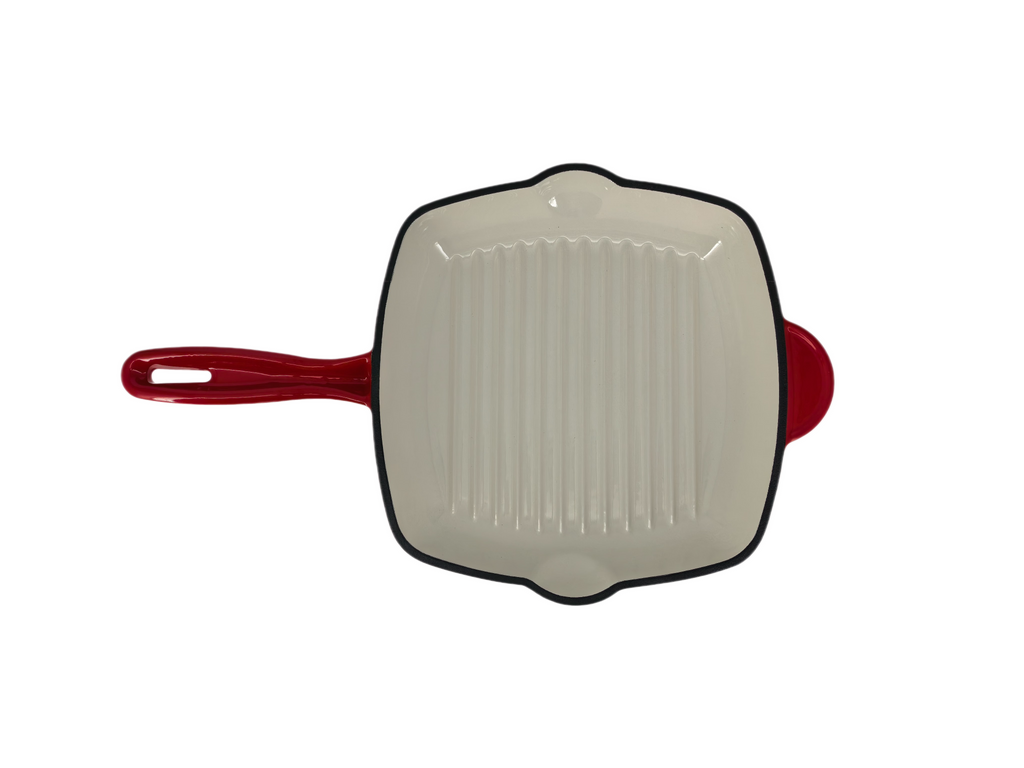 The North Point 9.5" Square Enameled Cast Iron Grill Pan in white with a red handle features raised ridges, a small red pouring spout, and is nonstick and oven safe—shown from above on a white background.
