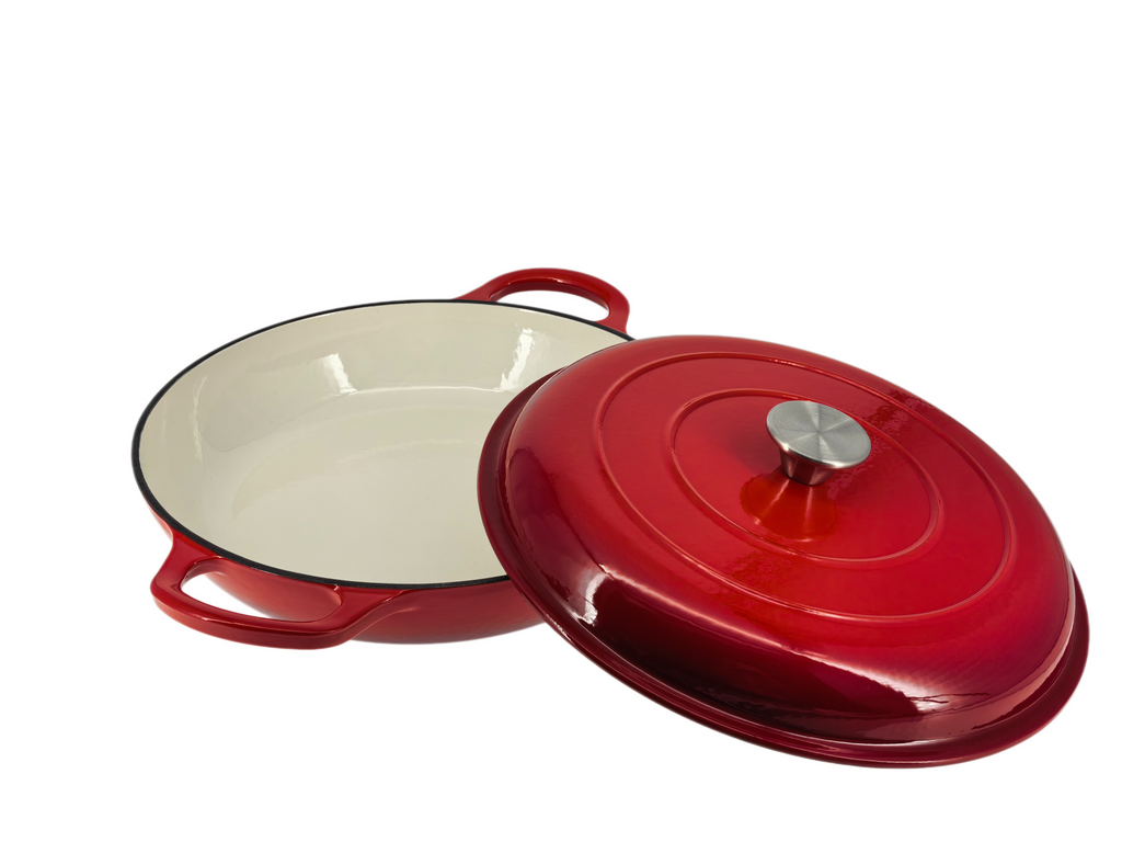The North Point Red Enameled Cast Iron Casserole Dish with Lid features double handles and a cream interior, shown here with its matching lid set to the side to reveal the oven-safe design.