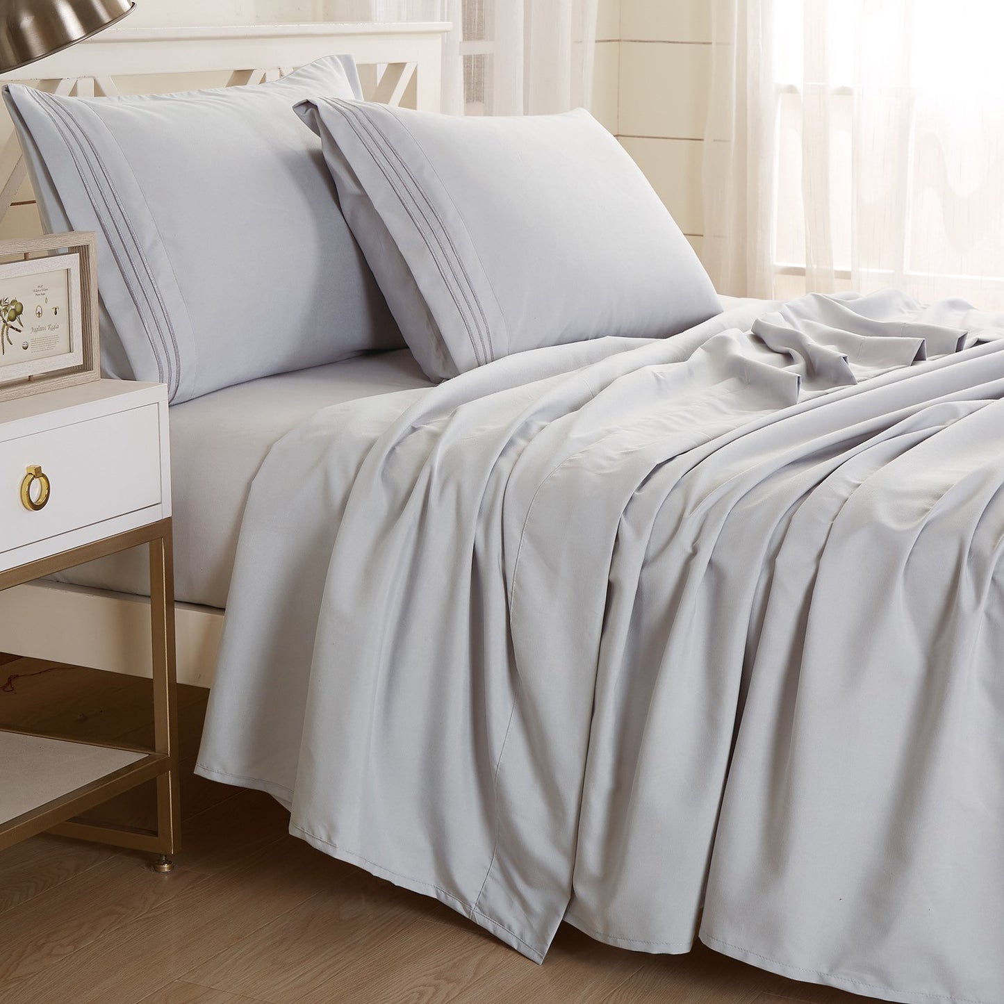 Gray-colored Textilia 4 Piece Bedsheet Set displayed on a bed. with two Pillow Case.