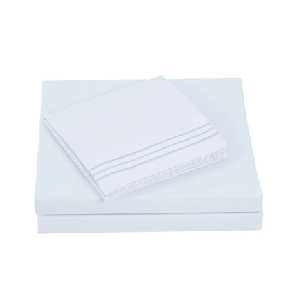 Textilia 4 Piece Bedsheet Set in white showcasing meticulous layering of the fitted sheet, flat sheet, and pillowcases.