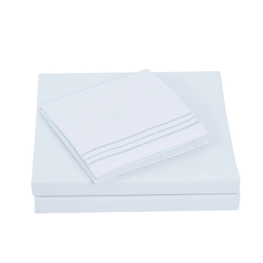 Textilia 4 Piece Bedsheet Set in white showcasing meticulous layering of the fitted sheet, flat sheet, and pillowcases.