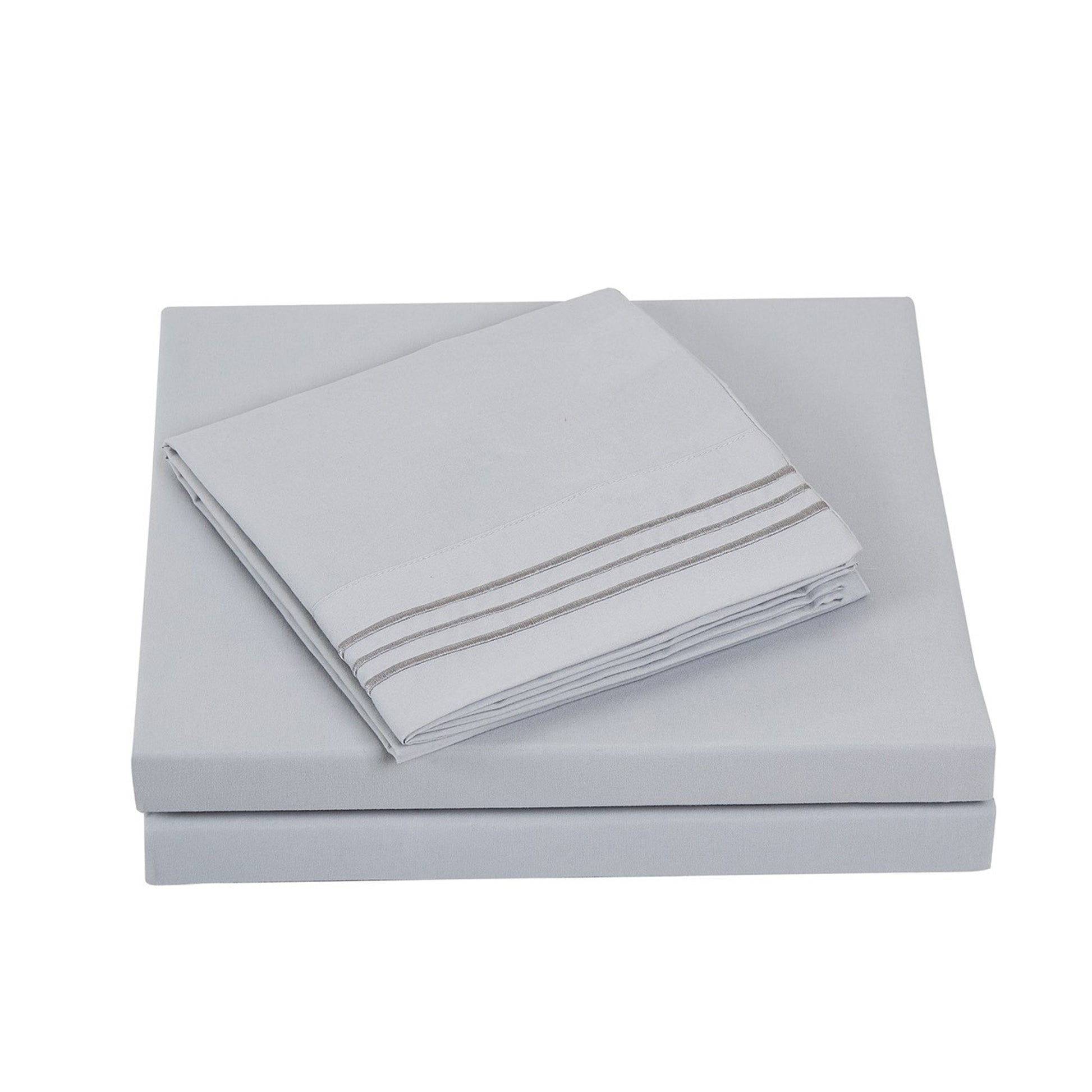 Folded Textilia 4 Piece Bedsheet Set in gray showcasing meticulous layering of the fitted sheet, flat sheet, and pillowcases tailored for king size beds.