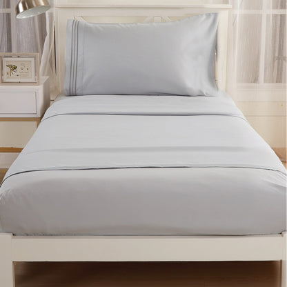 Gray-colored Textilia 3 Piece Bedsheet Set displayed on a bed.