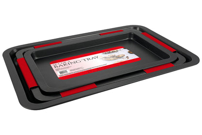 Le Regalo® Set of 3 Baking Tray. Three stacked black baking trays with red silicone grips on the handles, featuring a label on the top tray.