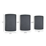 The Le Regalo Set of 3 Baking Tray by Le Regalo features durable, dark gray non-stick trays in sizes 17x11.5, 14.5x9.75, and 13.25x8.5 inches—perfect for all your baking needs.
