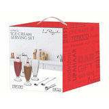 The Le Regalo 9 Piece Ice Cream Set includes four tall glass cups, four stainless steel spoons, and a metal scoop in a red gift-themed box, displayed against a kitchen backdrop.