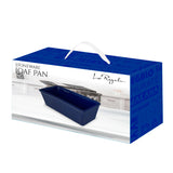 A blue Le Regalo Stoneware Loaf Pan sits on the kitchen counter, combining style and versatility. Its box displays Stoneware Loaf Pan and Le Regalo, with a white handle and blue sides—ideal for all your baking needs.
