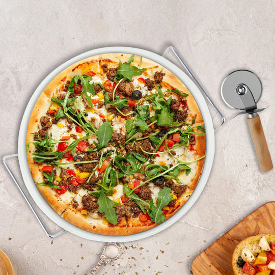 The Le Regalo 3 Piece Pizza Stone Set features a round white cordierite ceramic pizza stone with metal handles plus a metal pizza cutter with a wooden handle—an essential home chef set from Le Regalo.