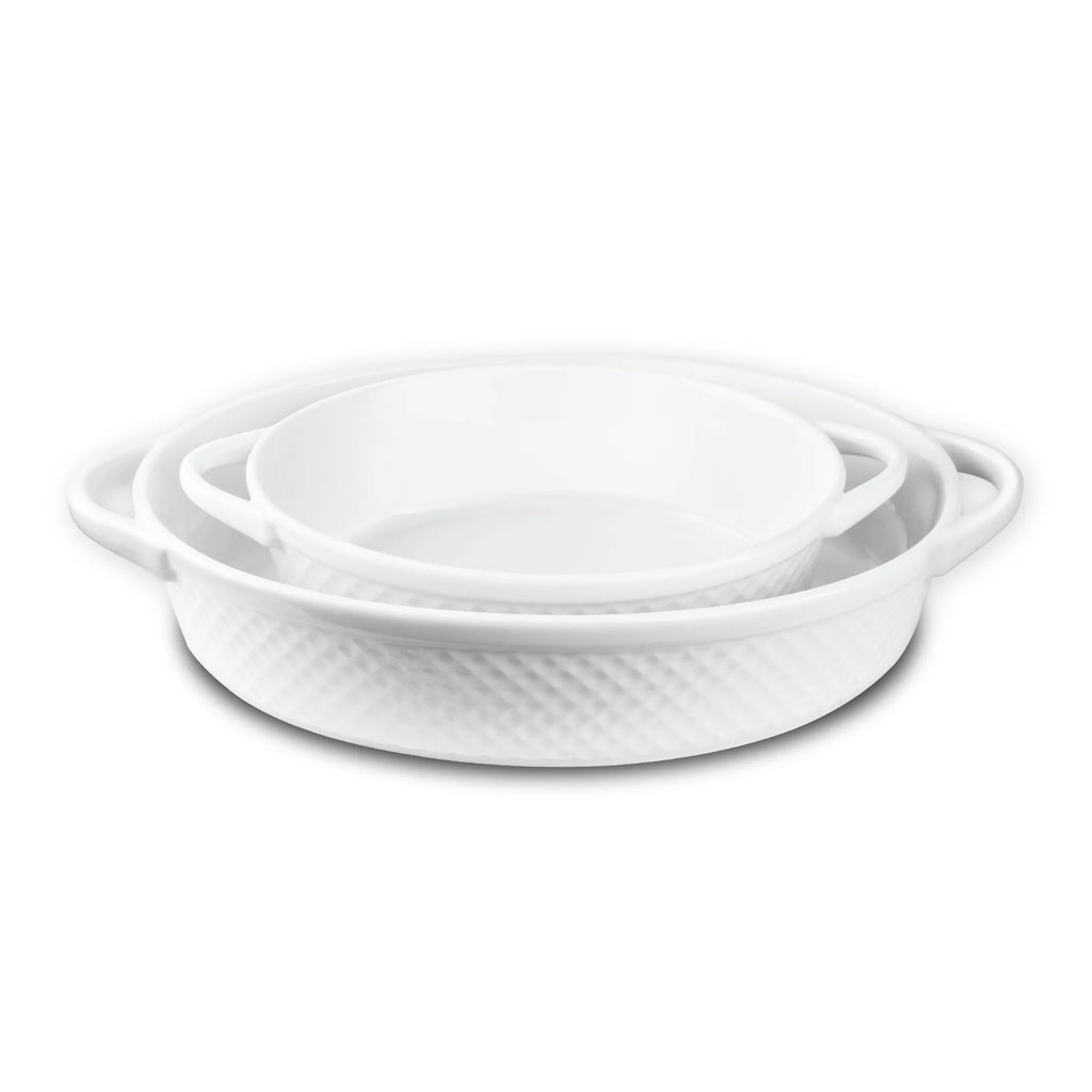 The Le Regalo 2 Piece Stoneware Oval Baker Set from Le Regalo includes two white, oven-safe stoneware dishes with handles and a subtle textured pattern, one nesting inside the other. Set is shown on a white background.