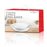The Le Regalo 2 Piece Stoneware Oval Baker Set features two white stoneware baking dishes with handles, shown on a kitchen countertop beside wooden utensils and a potted plant.