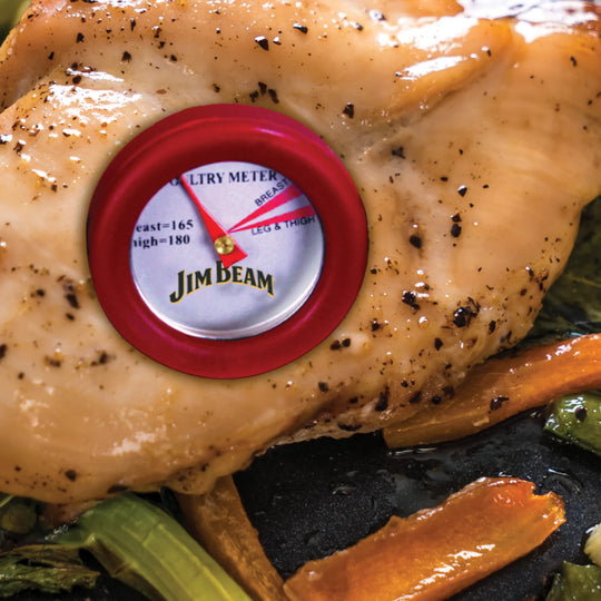 A close-up of cooked chicken breast with a Jim Beam 4 Piece Mini Thermometer Set thermometer inserted, resting on sautéed vegetables. The thermometer needle points to BREAST, ideal for perfectly monitoring doneness when grilling.