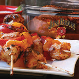 Grilled chicken and veggie skewers served on a white plate with the Jim Beam Vacuum Seal Marinade Container—ideal for BBQ lovers and fans of Jim Beam cooking accessories.