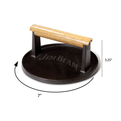 The Jim Beam Cast Iron Burger Press is a round, black grill press with a wooden handle and Jim Beam engraved on top. It measures 7 wide by 3.25 tall—perfect for even burger cooking and ideal for grilling enthusiasts.