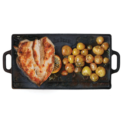 Grilled chicken breast and roasted baby potatoes with herbs served on the Jim Beam Cast Iron Reversible Grill/Griddle—perfect for stovetop cooking and features handles on both sides.