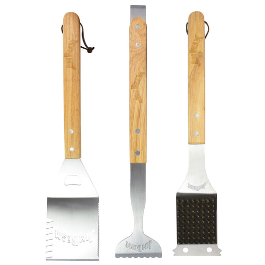 Three barbecue tools with wooden handles, including a spatula, grill brush, and tongs, on a white background.