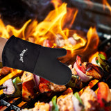 A hand wearing a Jim Beam Silicone Grilling Mitten is adjusting skewers of grilled meat and vegetables over an open flame on a barbecue grill.