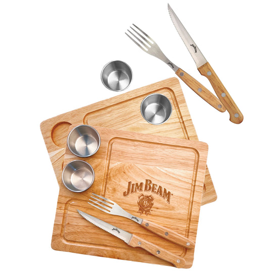 The Jim Beam 2 Pack Steak Serving Set includes parawood boards, a steak knife, fork, coarse salt, and two dipping sauce bowls—everything you need to serve BBQ steak with chimichurri, just like a pro.