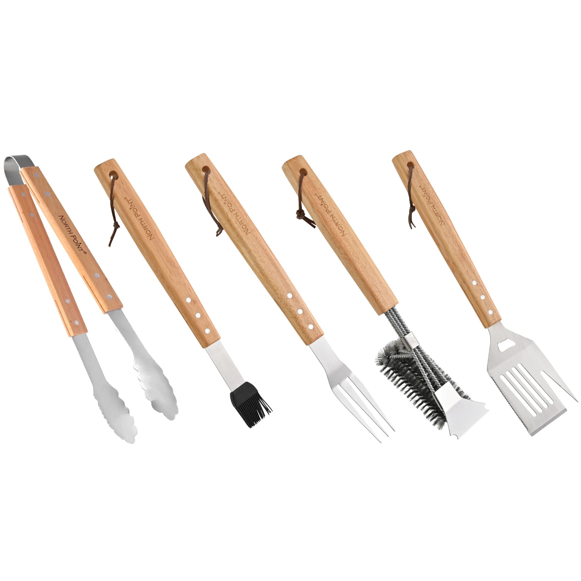 The North Point 5 Piece BBQ Tool Set features premium stainless steel tongs, basting brush, fork, cleaning brush, and spatula with wooden handles—all neatly arranged on a white background.
