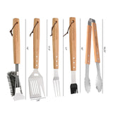 The North Point 5 Piece BBQ Tool Set features stainless steel grill brush, spatula, fork, basting brush, and tongs—all with wooden handles, measurement markings, and leather hanging loops for added grilling convenience.