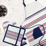 The Textilia 3 Piece Kitchen Set by Textilia, featuring a striped design with a blue pocket, oven mitt, and quilted pot holder, is displayed on white marble beside a bowl of blackberries.